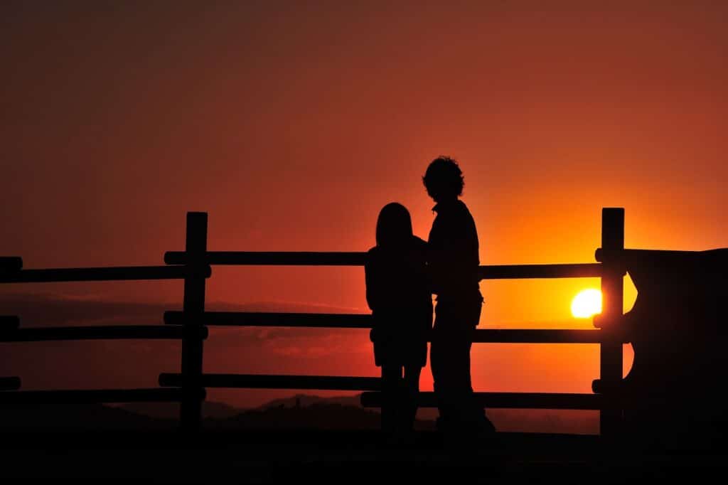 adult and child at sunset