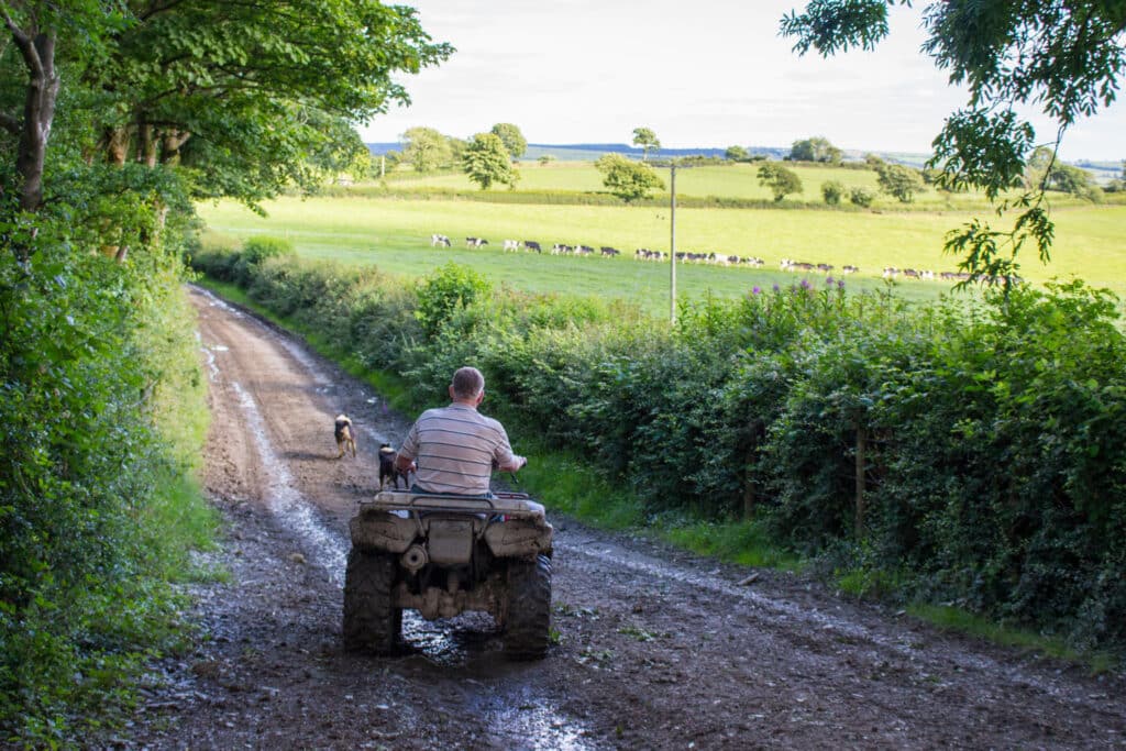 Farmer on quad bike after the rain